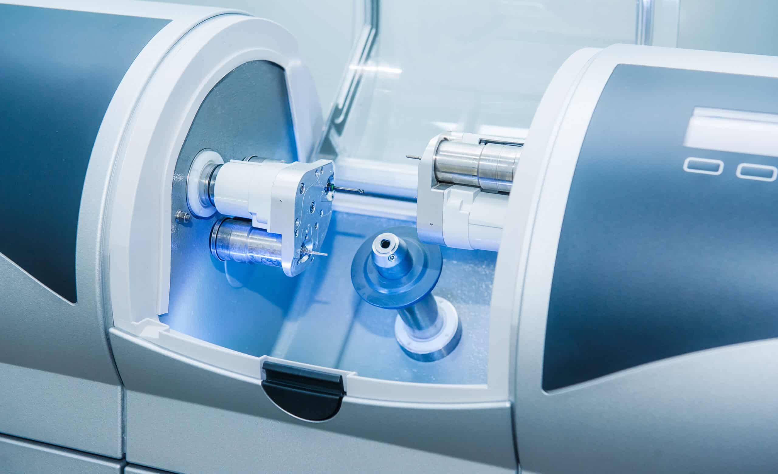 CAD CAM dental computer-aided machine in a highly modern dental laboratory for prosthesis and crowns milling. Dentistry, prostodontics, prosthetics and medical computer technology concept.