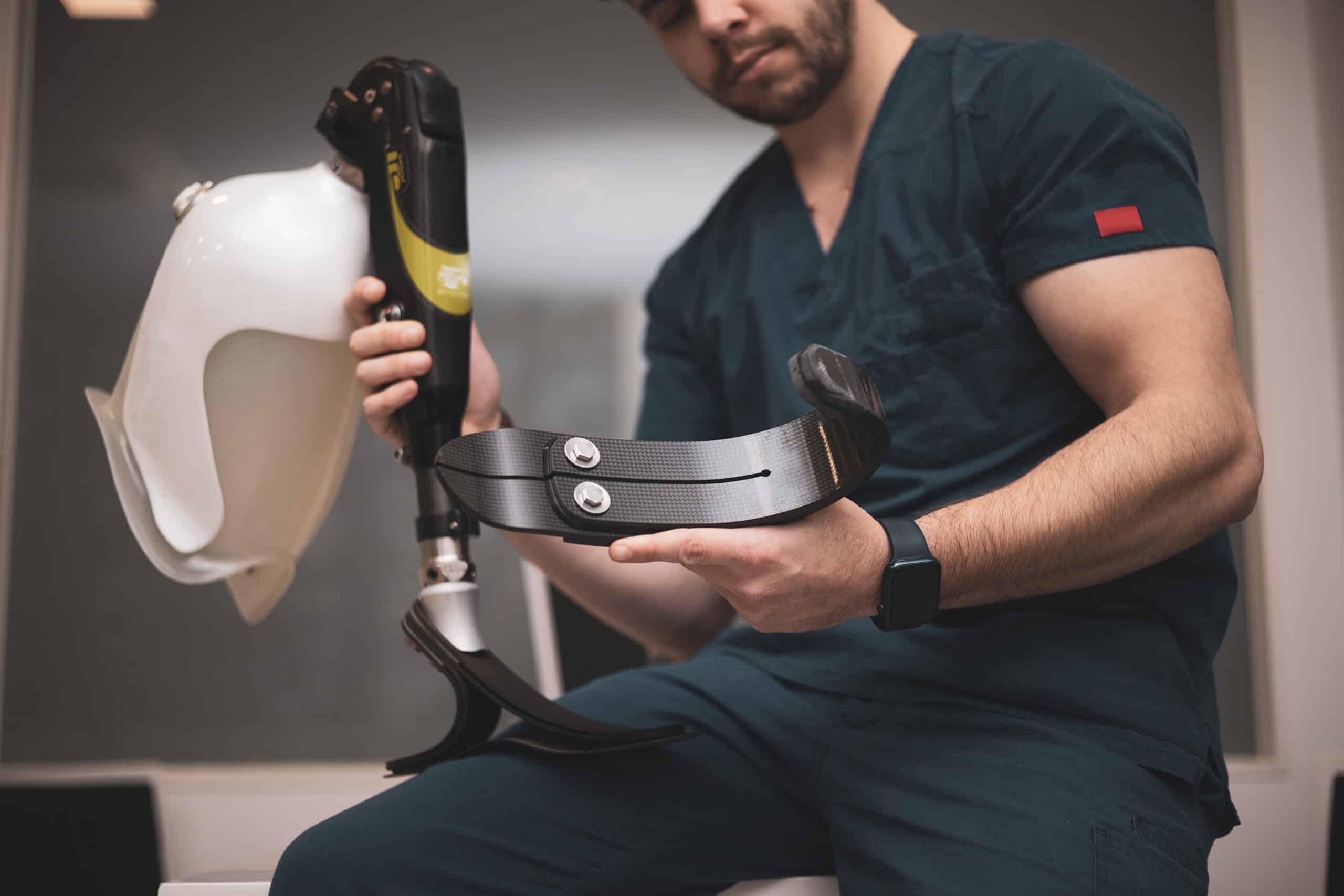 an orthopedist fixing a prosthetic leg for an athlete.bionic leg.