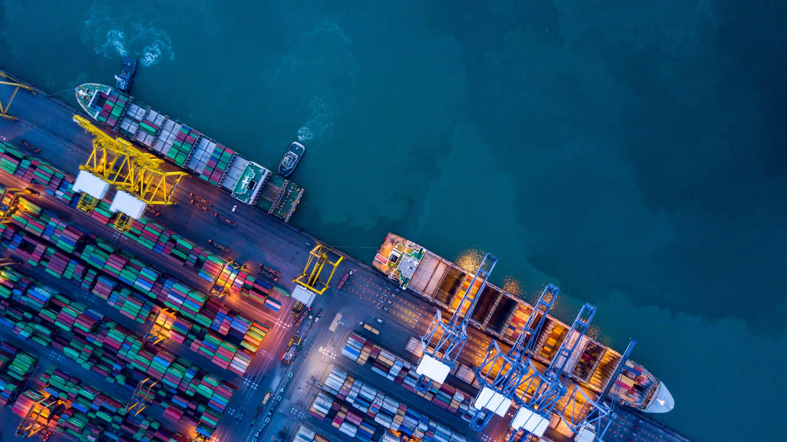 Aerial view container cargo ship at commercial sea port, Global business logistic import export transportation international by container cargo ship, Container cargo ship freight shipping at night.